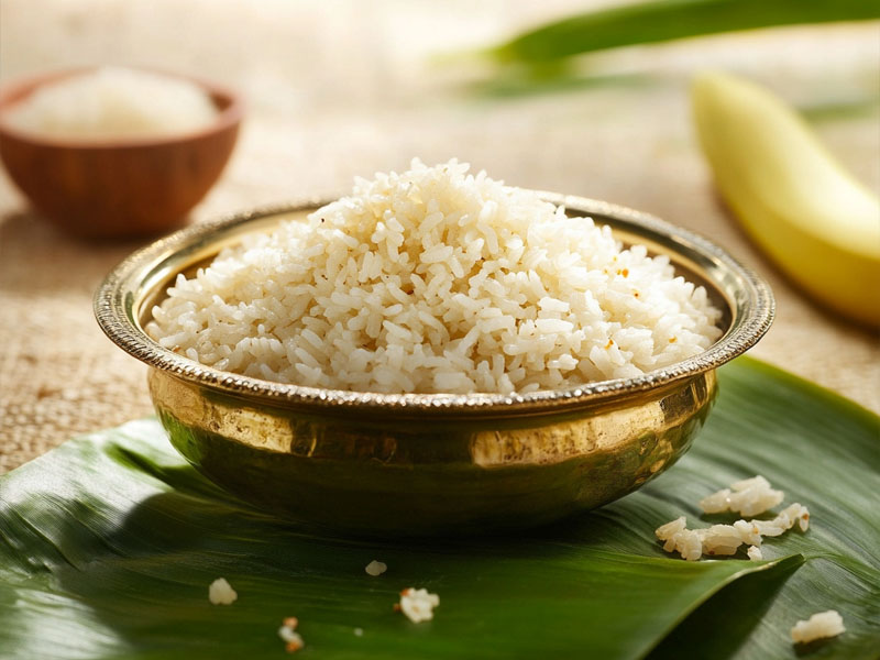 Fragrant Indrayani rice in a brass bowl on banana leaf