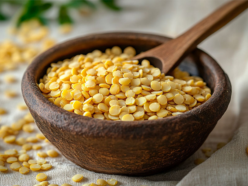 Organic yellow moong dal in a clay bowl